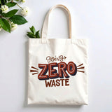 Plovera Co Going Zero Waste tote laid flat on pale grey with white blossom and green leaves