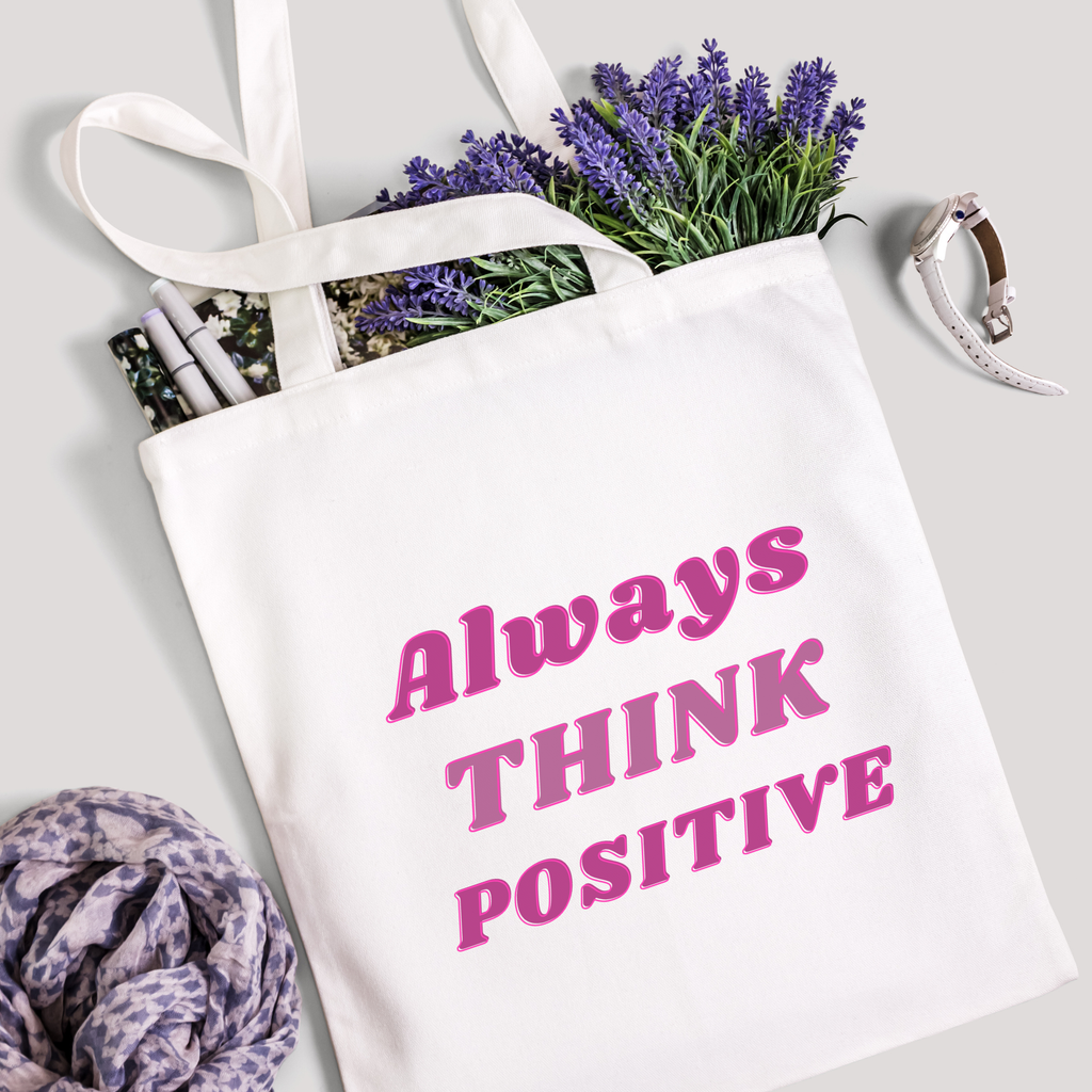 Always Think Positive tote packed with lavender stems and marker pens, leopard-print scarf below