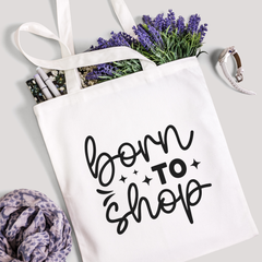 Born To Shop tote filled with lavender stems and marker pens, leopard-print scarf below