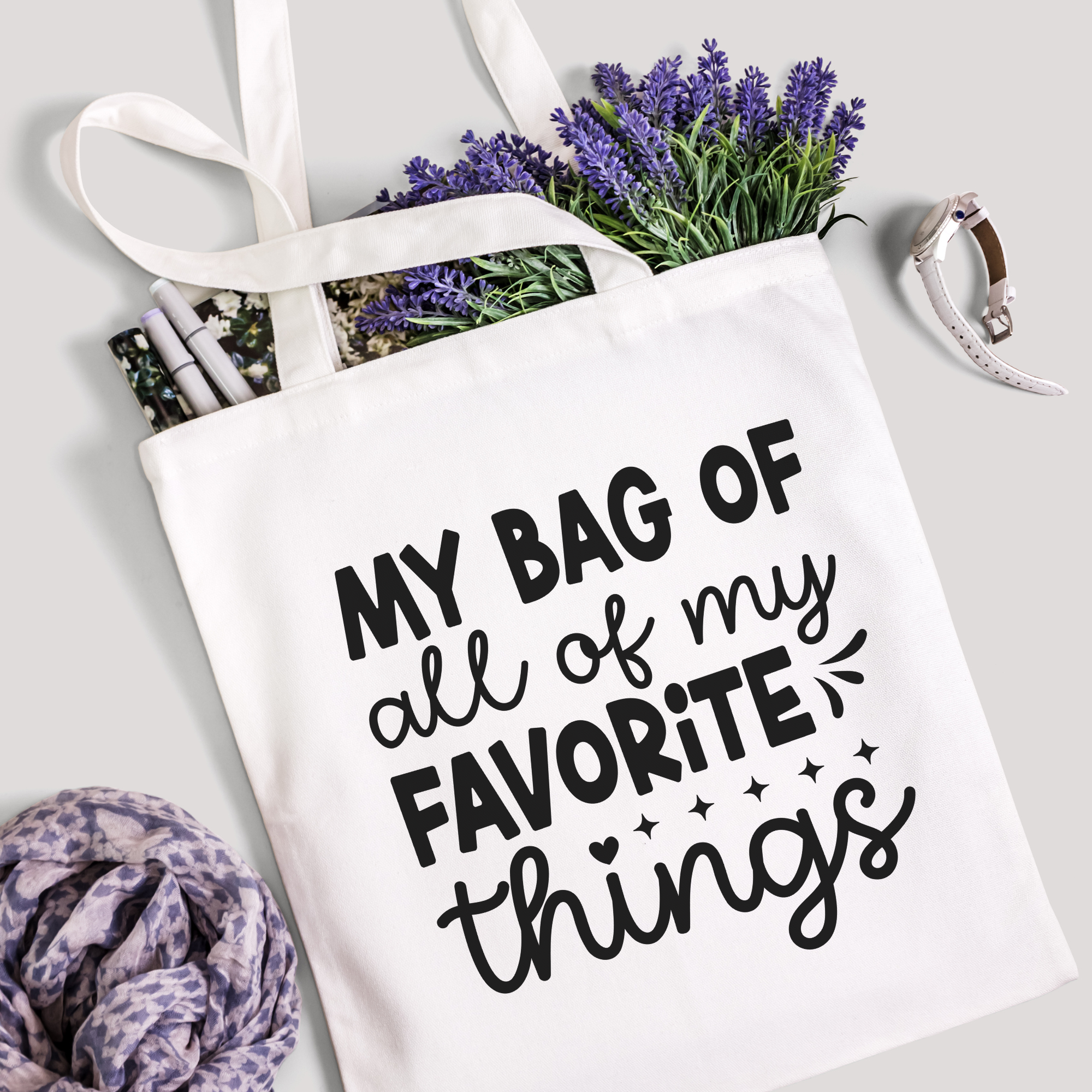 Favorite Things tote filled with lavender stems and marker pens, leopard-print scarf below