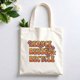 Plovera Co Reduce Reuse Recycle tote laid flat on pale grey with white blossom and green leaves