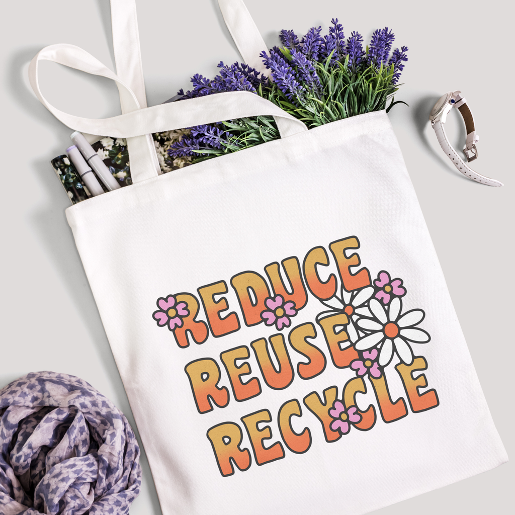 Reduce Reuse Recycle tote filled with lavender stems and marker pens, leopard-print scarf below