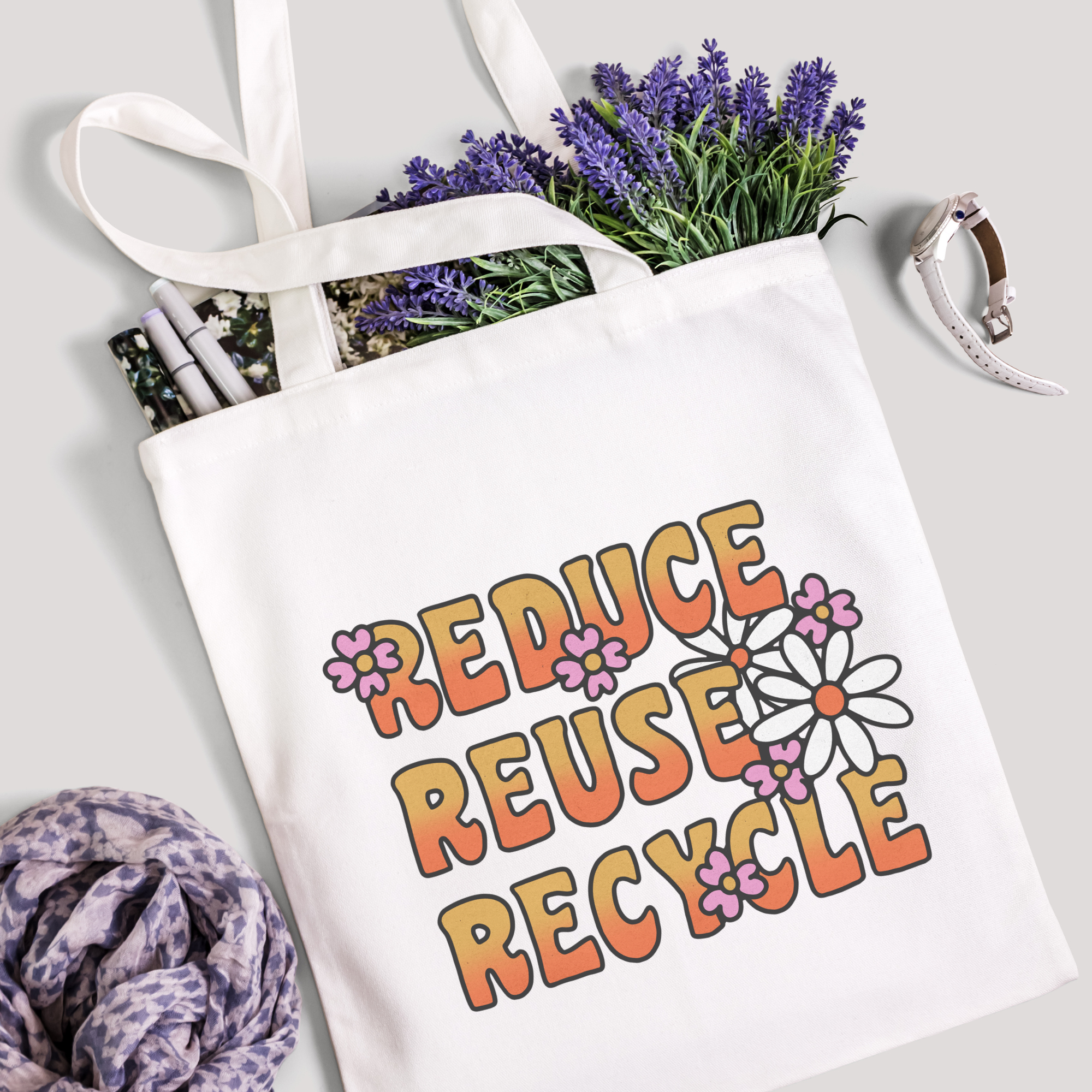 Reduce Reuse Recycle tote filled with lavender stems and marker pens, leopard-print scarf below
