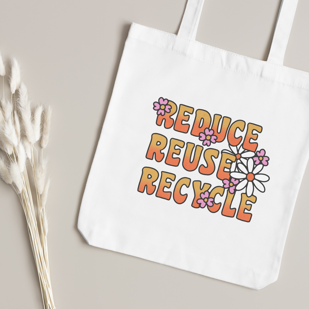 Orange lettering and daisy print close up, dried bunny-tail grass on a taupe surface