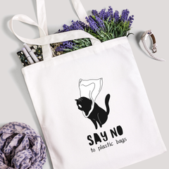Say No to Plastic Bags tote filled with lavender stems and marker pens, leopard-print scarf below
