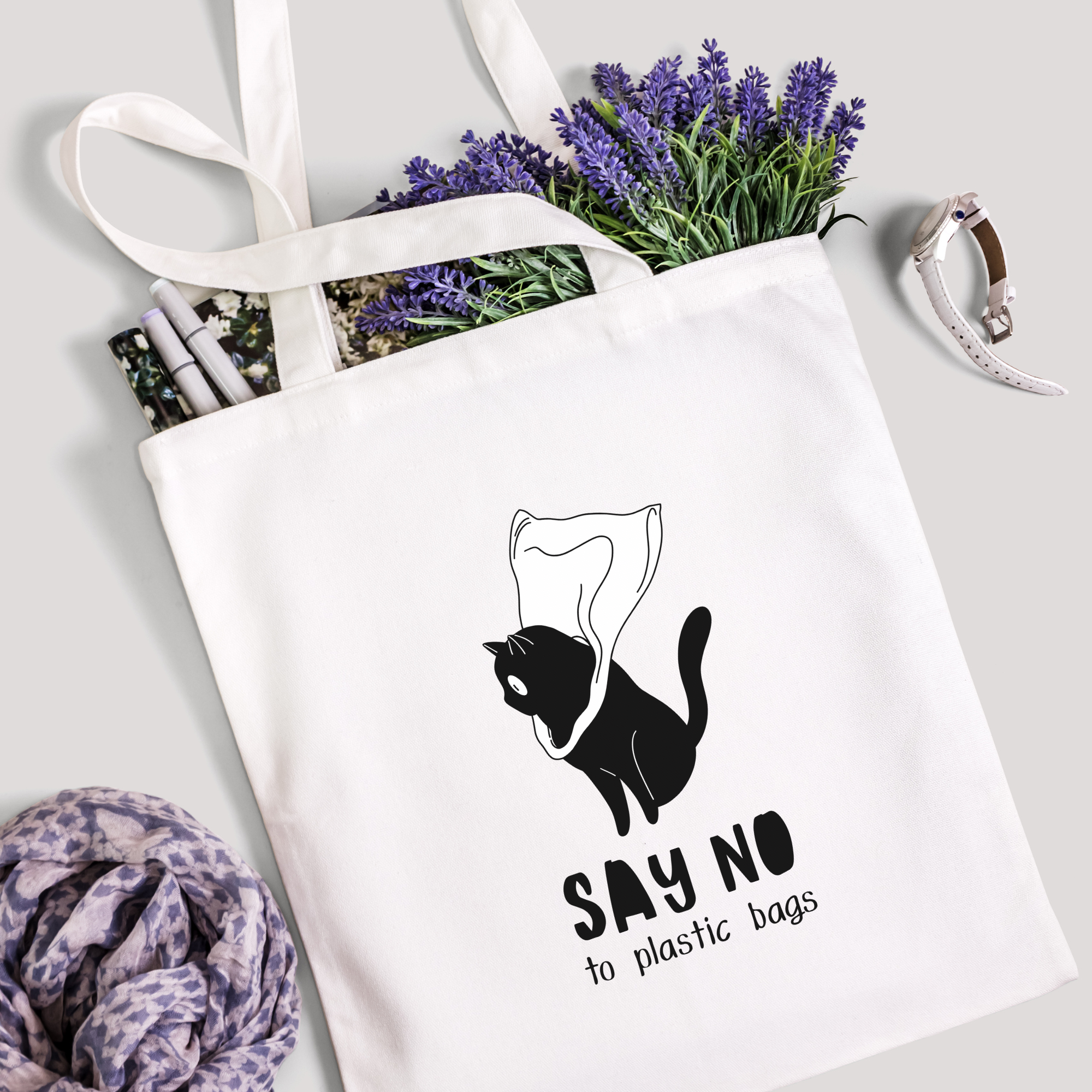 Say No to Plastic Bags tote filled with lavender stems and marker pens, leopard-print scarf below