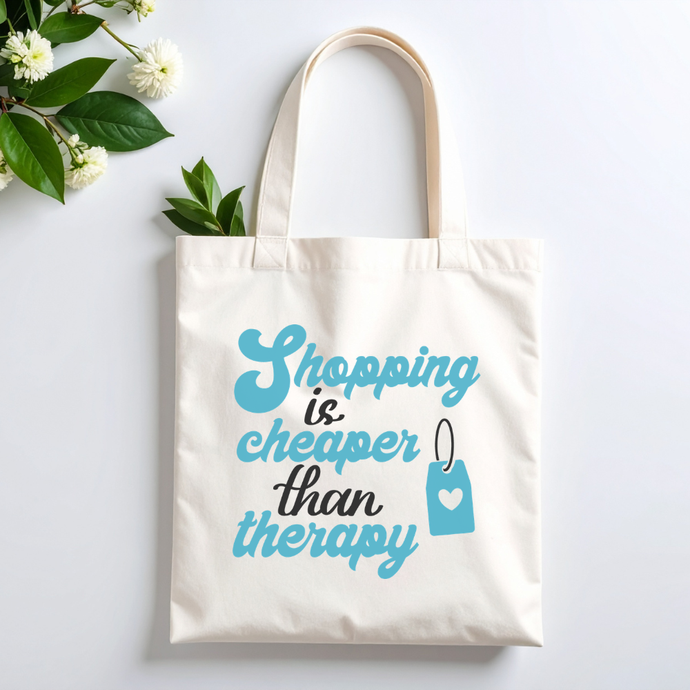 Plovera Co Shopping Is Cheaper Than Therapy tote laid flat with white blossom on pale grey