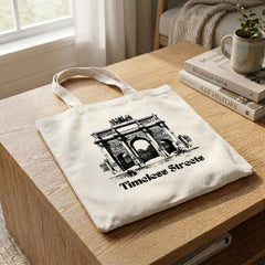 Timeless Streets tote on an oak coffee table beside stacked design books and a potted plant