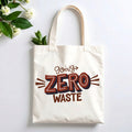 Plovera Co Going Zero Waste tote laid flat on pale grey with white blossom and green leaves